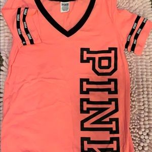 A Victoria Secret PINK shirt in size xs.